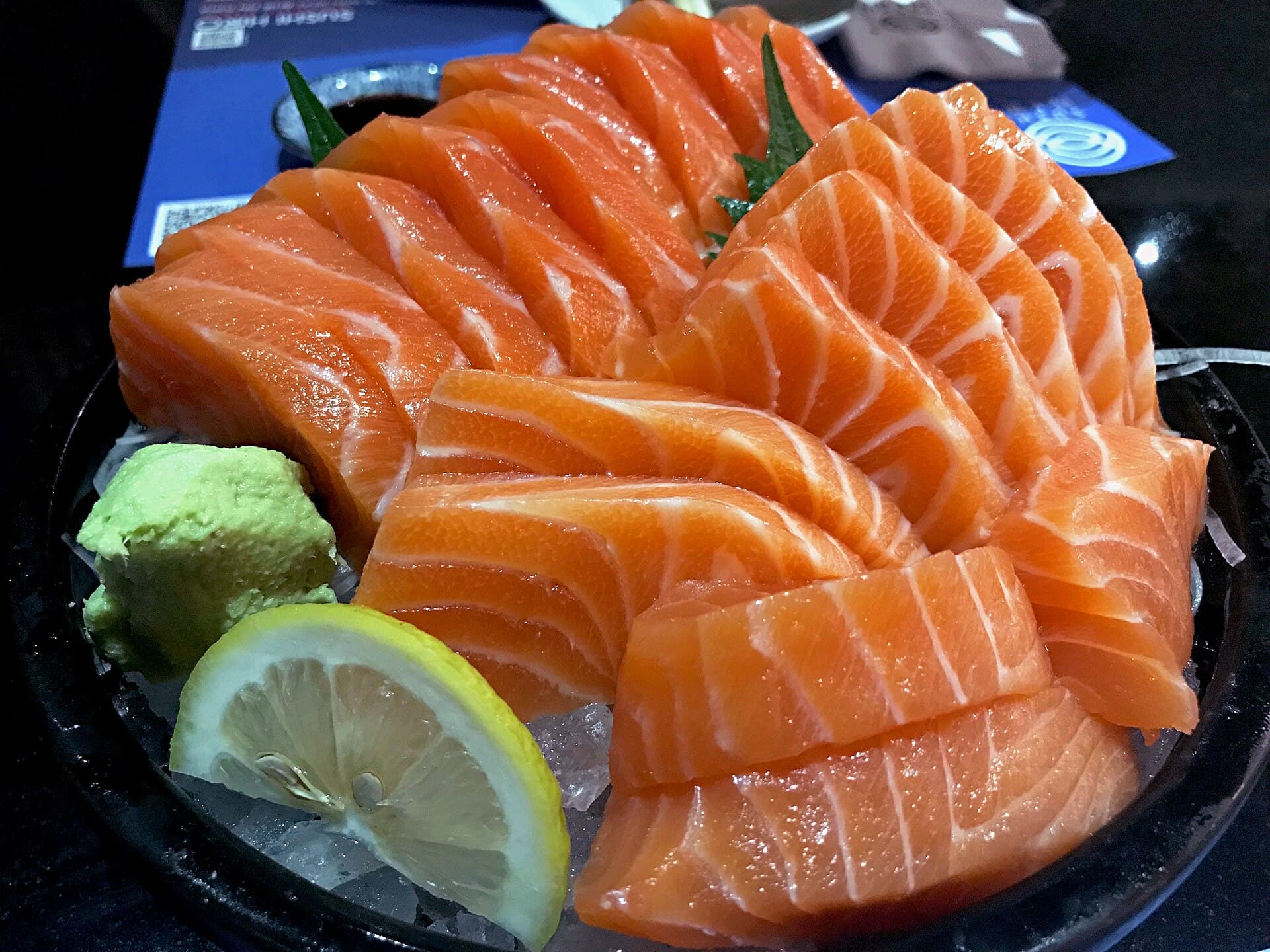 Salmon sashimi with a lemon wedge